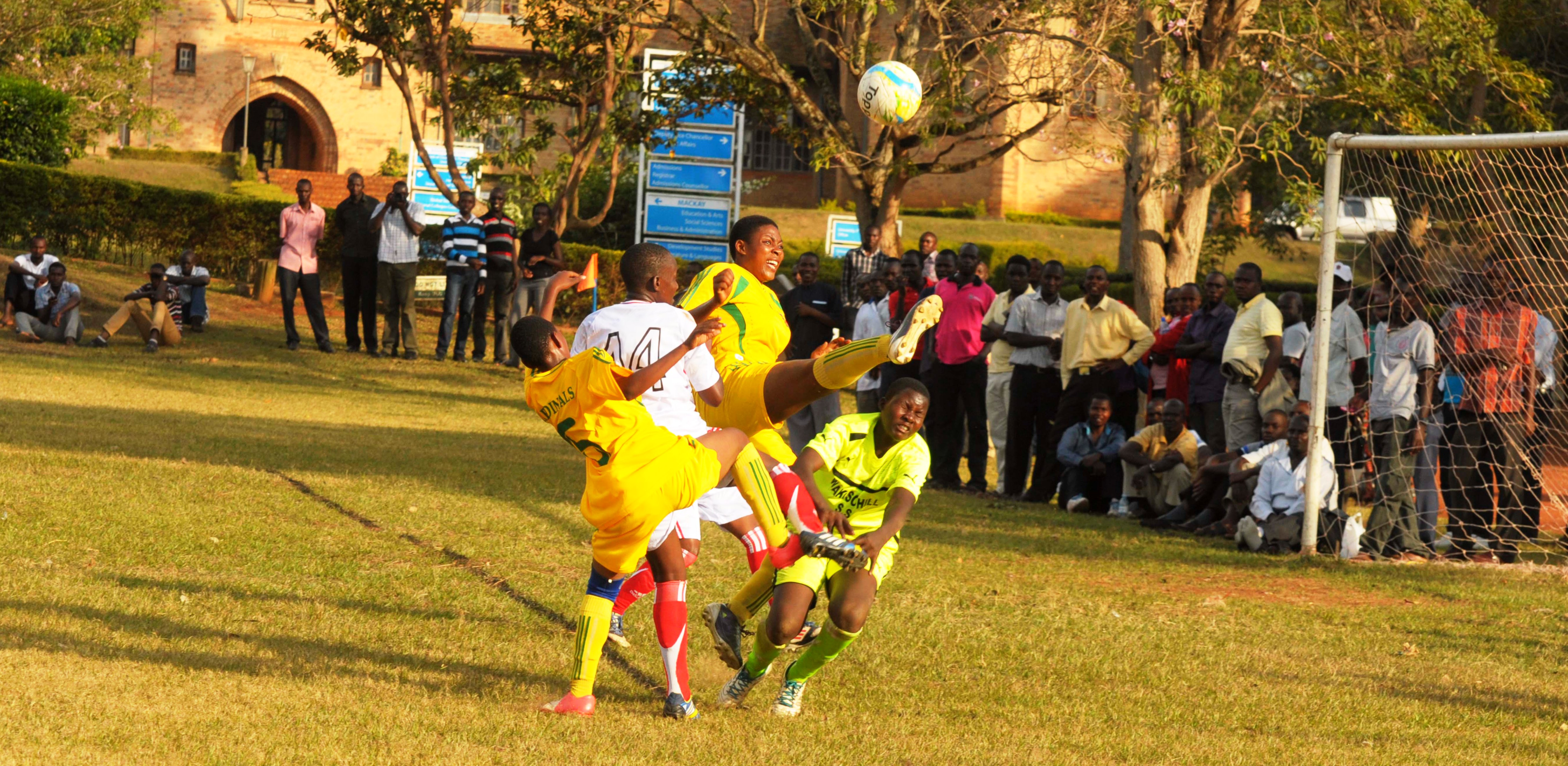 UCU Lady Cardinals' goal scorer Vicky Nakibuuka (2nd right) attempts to score agains Wakiso Hill School's Penianah Adwono (right) in a Women Elite league game played at UCU in Mukono