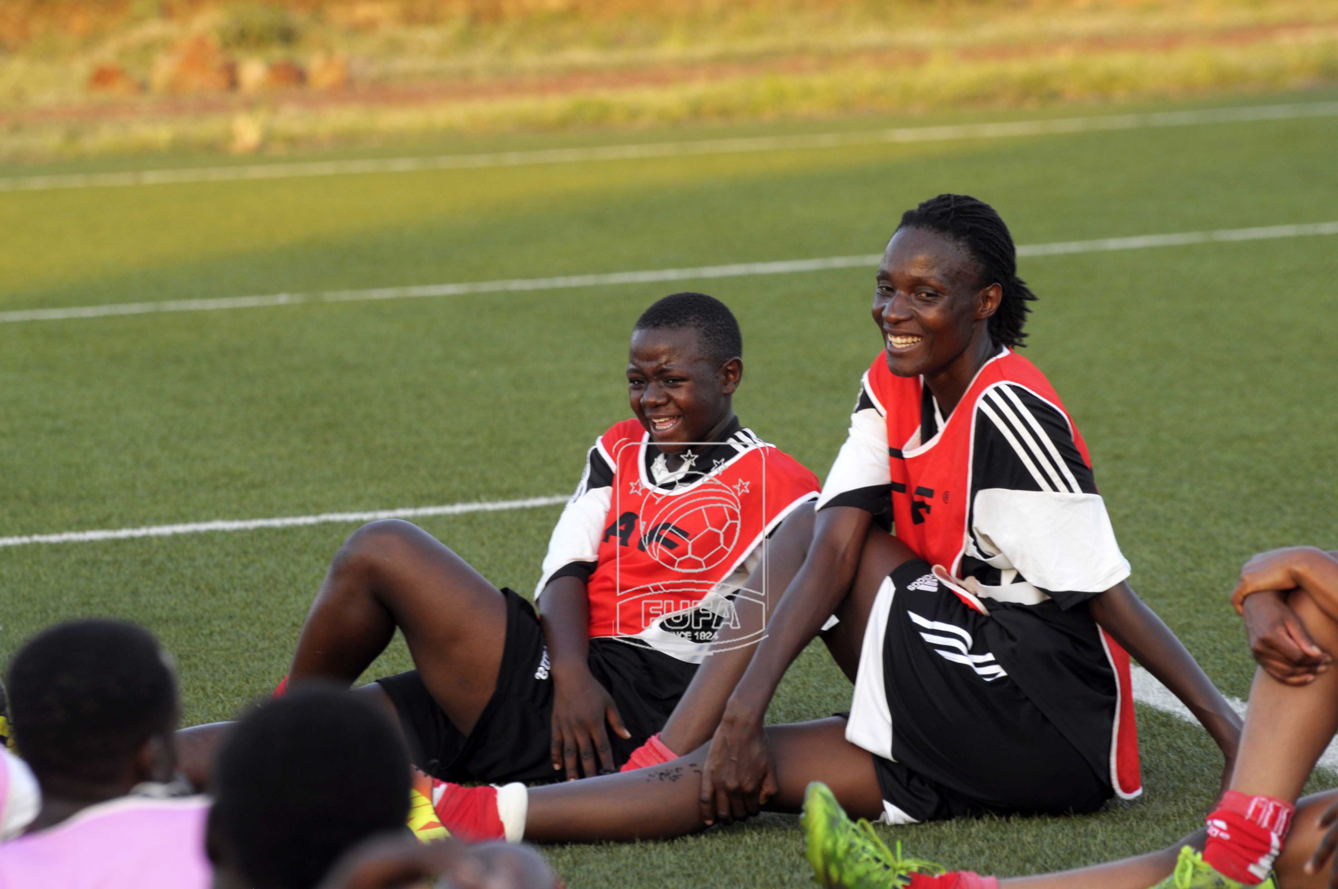 Crested Cranes captain Christine Wanyana (right) and Joan Nakirya relaxing after training