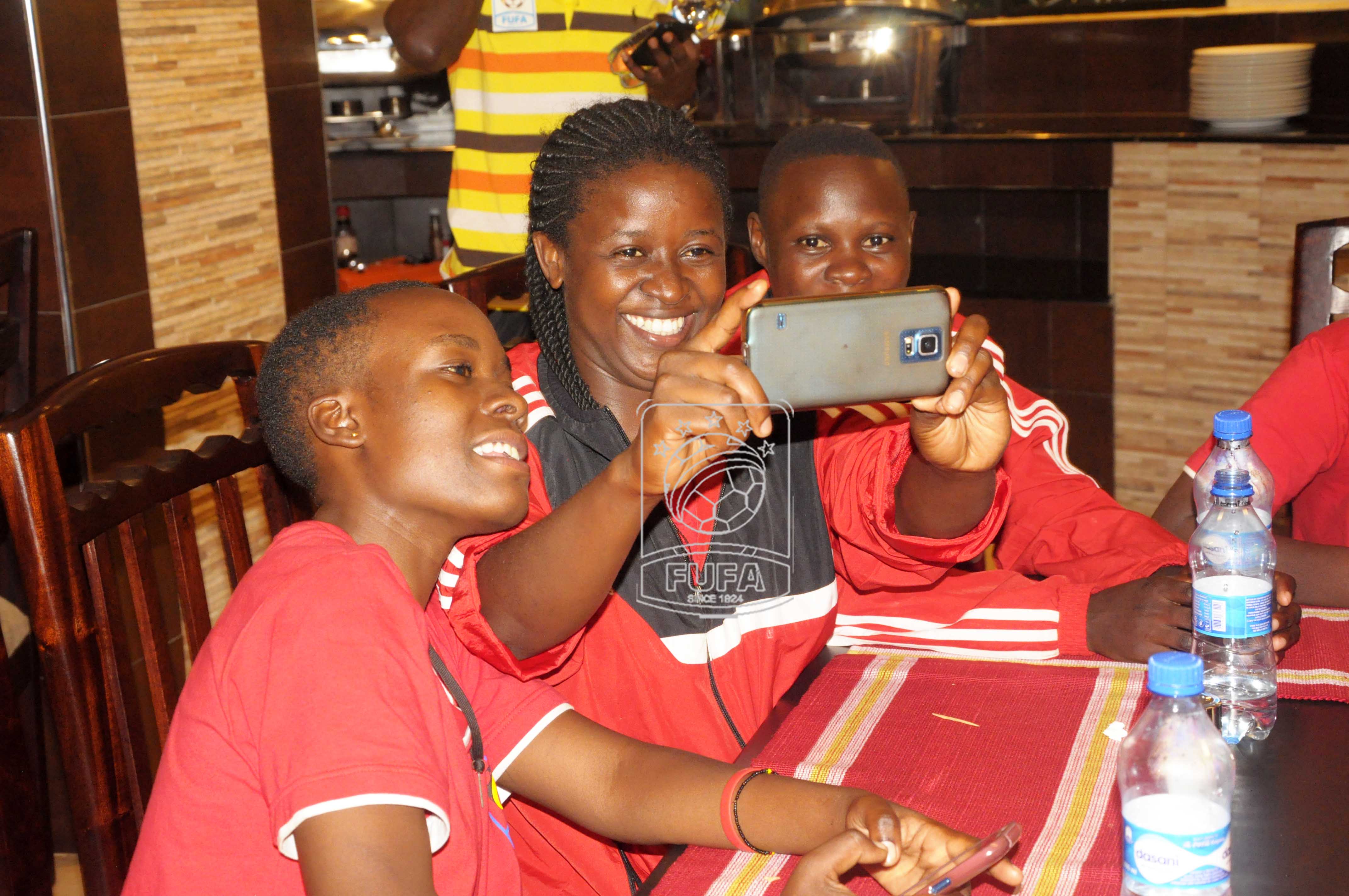 L-R Crested Cranes players Naome Nagadya, Shakira Hussein Nalwoga and Florence Nakalule taking a selfie.