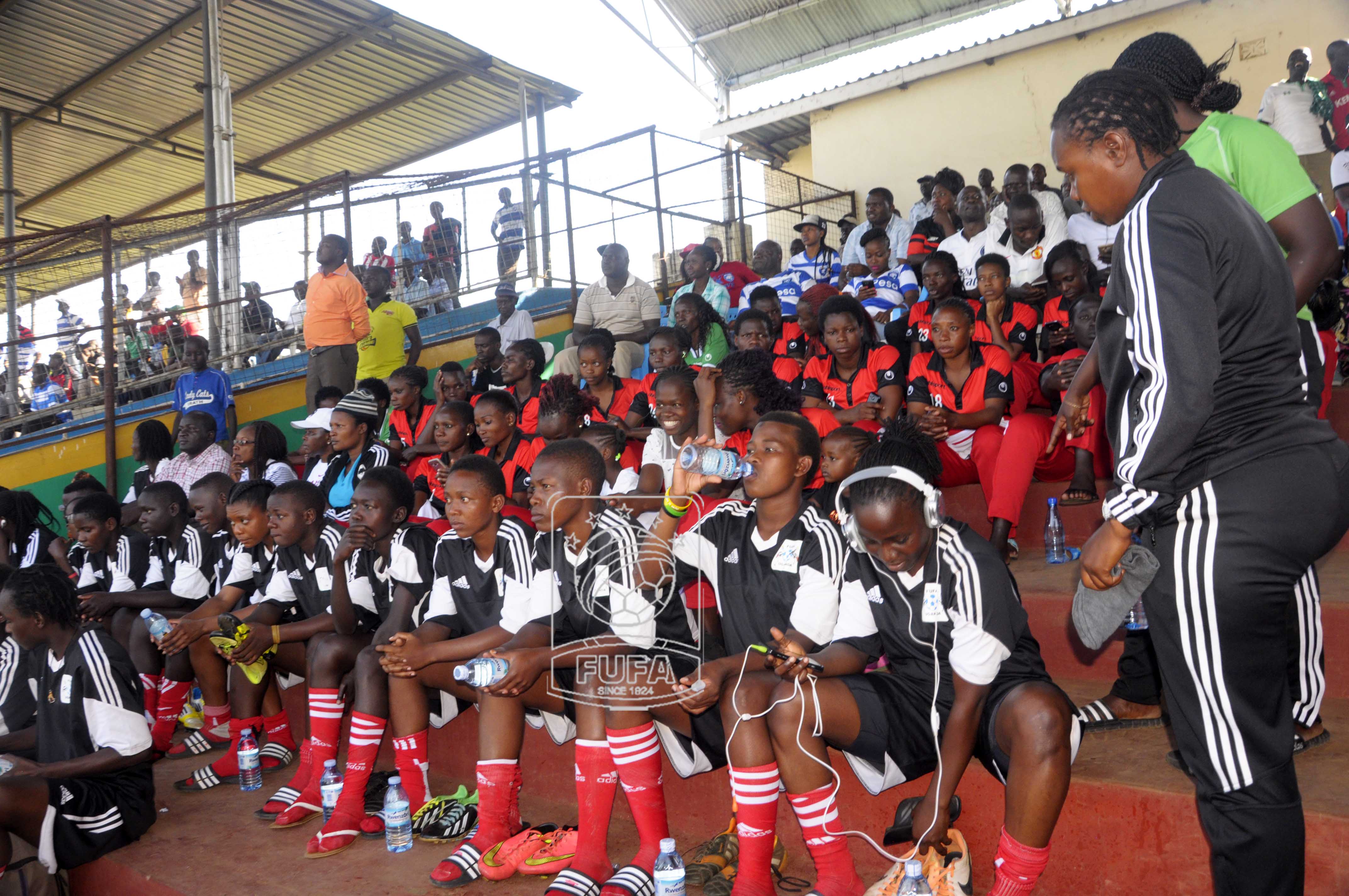 Crested Cranes players watching the Kenyan Premier League game between Chemelil FC and AFC Leopard with their Kenyan opponents in tomorrow's game seated behind them in red2