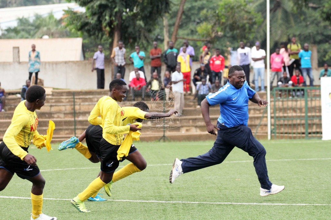 Kawempe Muslim Ladies FC Coach Ayub Khalifan (blue) celebrates victory with some of his players