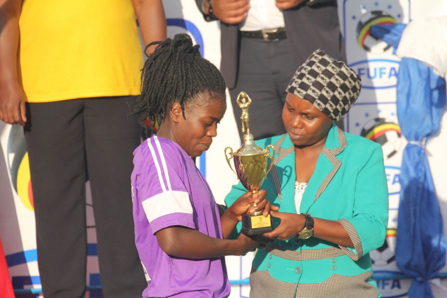 UCU captain Maureen Kinavudori recievses the Most Valuable Player accolade from Crested Cranes Head Coach Faridah Bulega